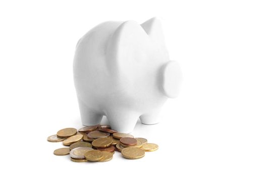 A piggy bank standing next to some money. All isolated on white background.