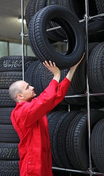 A mechanist working hard in a tire workshop.