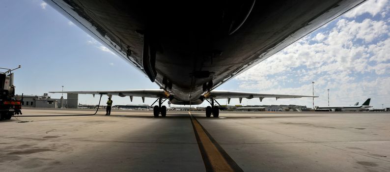 View of an airliner parked during refueling.
