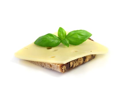 A fine buttered bread with cheese and fresh basil. All isolated on white background.
** Note: Shallow depth of field