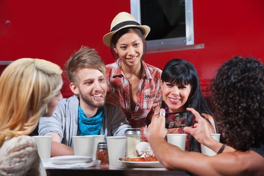 Friends smiling for photos at restaurant