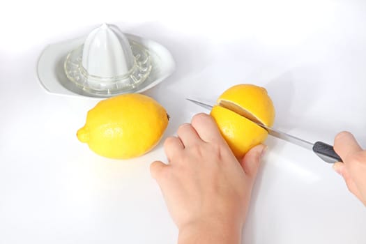 A person cutting lemons. All isolated on white background.
** Note: Shallow depth of field.