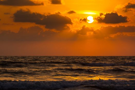 Ocean sunset concept background. Baga beach. Goa, India