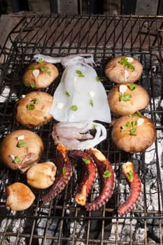 Porto bello mushrooms and sea food on barbecue, Greek cuisine