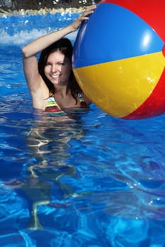 A very attractive young woman having fun in the swimming pool.