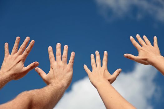 Two persons lifting their hands up in the air.