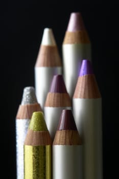 Glitter eyeshadow pencils with black background