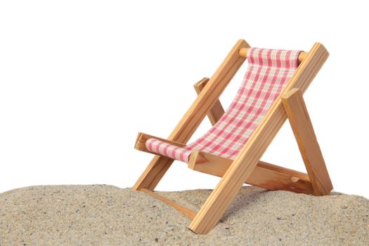 A standard deck chair standing on a beach. All isolated on white background.