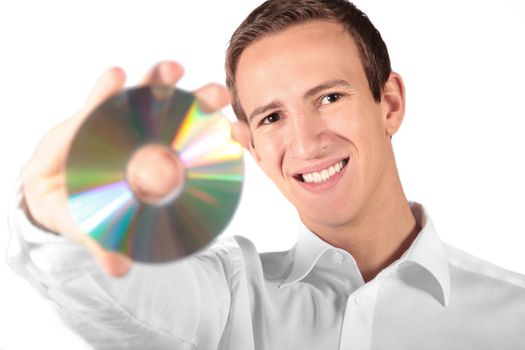 A young attractive man holding a cd or dvd. All isolated on white background.