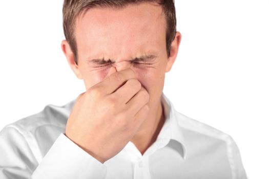 A young man sneezing. All isolated on white background.