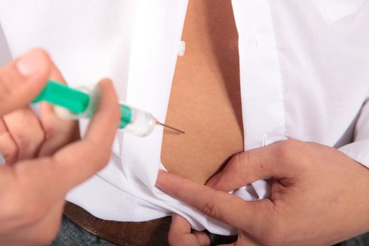 A diabetic giving himself a shot of insulin
** Note: Shallow depth of field.