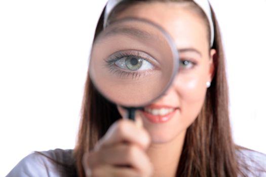 An attractive young woman using a magnifier. All isolated on white background.