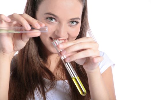 An attractive chemistry student holding two test tubes. All isolated on white background.