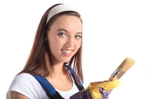 An attractive young woman holding a paint brush. All isolated on white backhground.