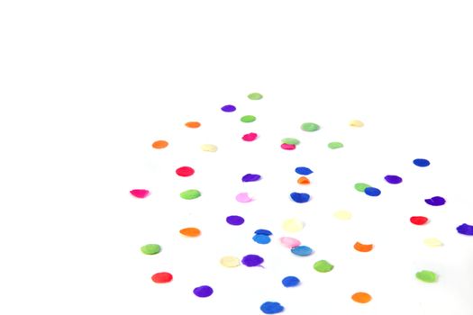 Some confetti lying on a plain white background.