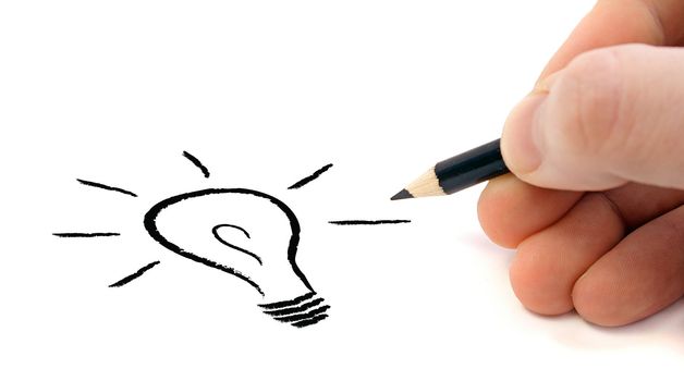 A human hand sketching a stylized light bulb. All on white background.