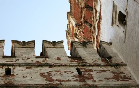 Fragment of old brick wall with white stucco