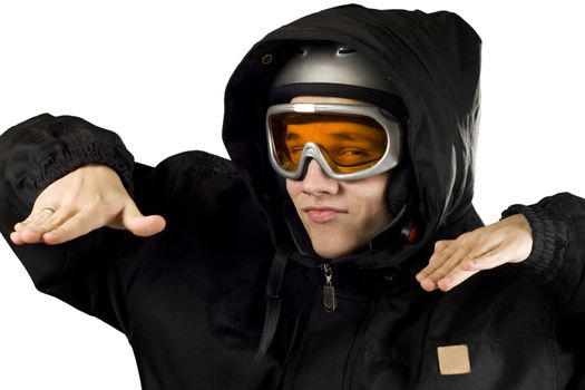 Teenager boy with orange goggles and black suit with hood and helmet acting like he's snowboarding.

Studio shot.