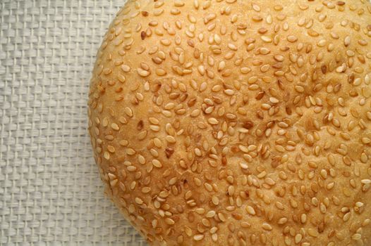 Bread with sesame seeds on a linen napkin