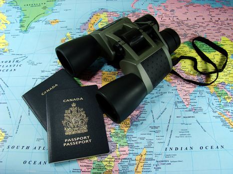 Ready for adventure. Binoculars, map and travel passports.