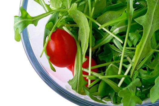 Salad with rugola and cherry tomato in glass bowl (top) with clipping path