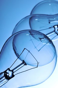 Close-up of three lightbulbs isolated on blue