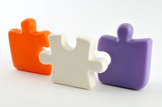 Three colorful puzzle pieces isolated on white