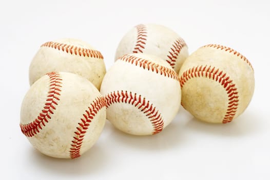 a macro of several baseballs on white