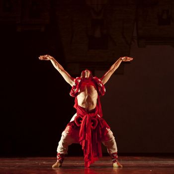 CHENGDU - OCT 18: Chinese Qiang national dancer performs folk dance on stage at JINCHENG theater on Oct 18, 2011 in Chengdu, China.