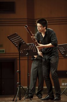 CHENGDU - JUN 20: bassoonist perform on wind music chamber music concert at odeum of Sichuan Conservatory of Music on Jun 20,2012 in Chengdu,China.