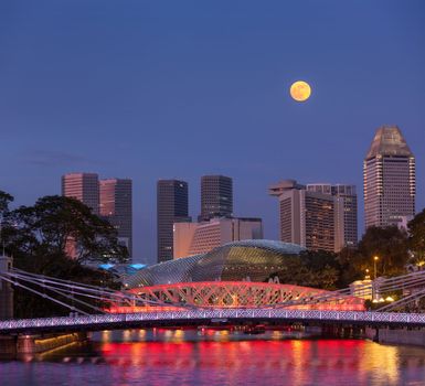 Singapore skyline. Singapore river and Cavenagh Bridge in the evening