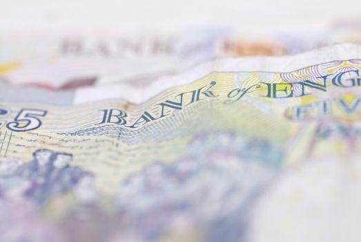 Macro image of English bank notes. Focus on �5 note.