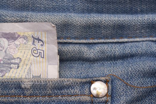 Macro photograph of �5 sterling in a Jeans pocket.