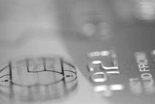 Black and white macro images of debit card. Focus on numbers and Chip.