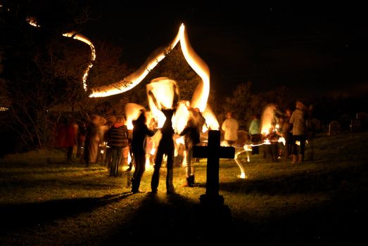 Light trails in church yard with families gathered.