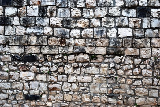 Fragment of old grunge stone wall