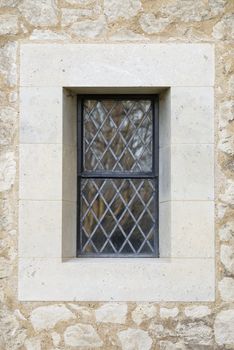 Central leaded Church window surrounded by stonework.