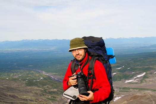 Kamchatka.Turist-photographer on the background of volcanos