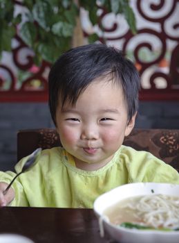 a cute baby is eating 