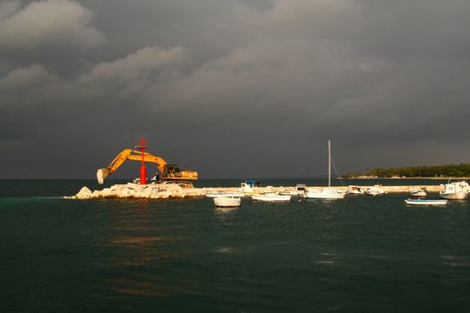 Landscape with an excavator on the Adriatic coast. 
