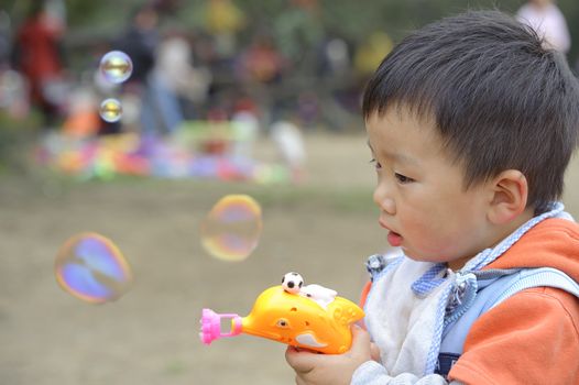 child blowing soap bubbles