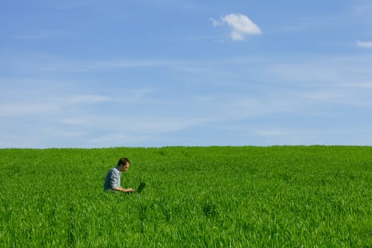 Young man using a laptop outdoors