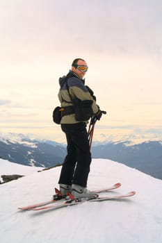 Skier on peak of the mountain. Alps