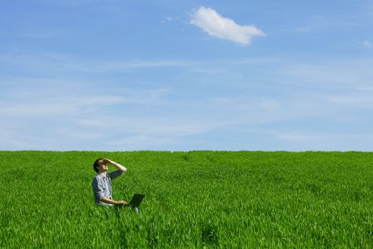 Young man using a laptop outdoors