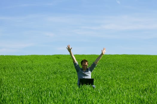 Young man using a laptop outdoors