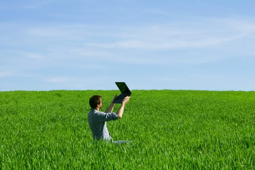 Young man using a laptop outdoors