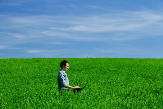 Young man using a laptop outdoors