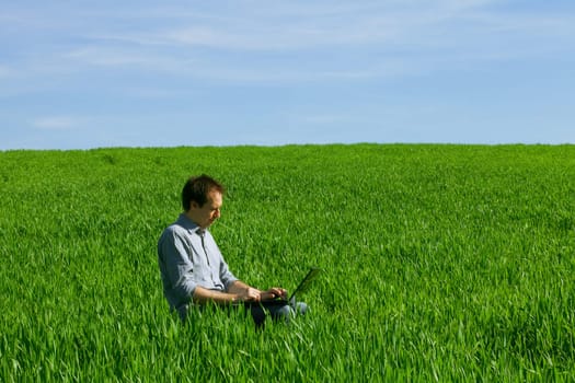 Young man using a laptop outdoors