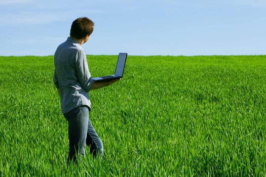 Young man using a laptop outdoors