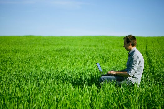 Young man using a laptop outdoors